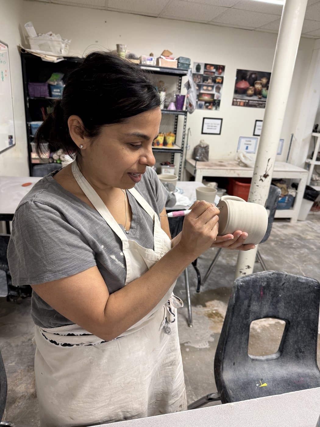 Mamata working on a pot in the studio